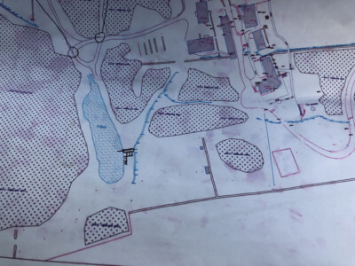 Coloured site drawing showing hatched zones and marked water features