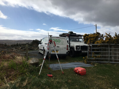 Tripod and levelling staff beside the 360 Surveys van at a moorland gate
